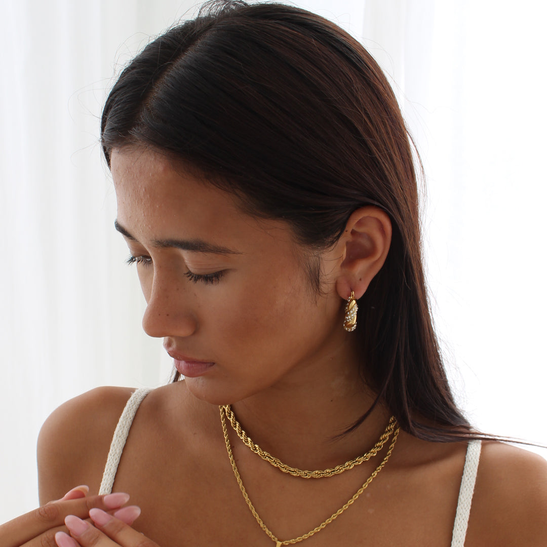HOLLYWOOD. Gold Crystal Twist Croissant Hoop Earrings